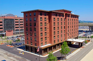The Hampton Inn, a red brick building, from a distance